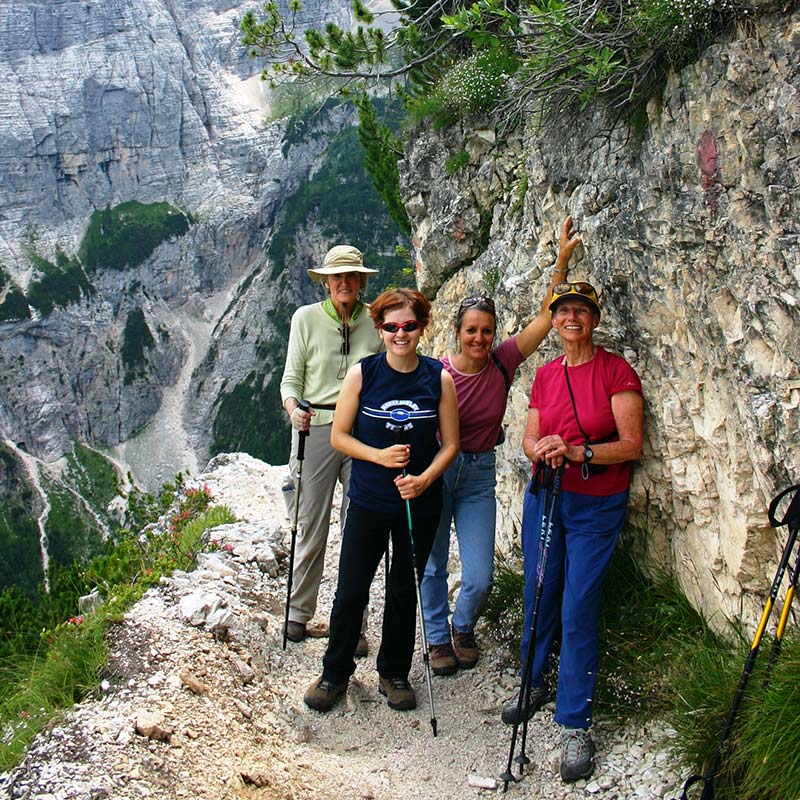 4 women on hiking trail in the Dolomites